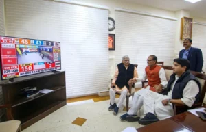 Madhya Pradesh Chief Minister Shivraj Singh Chouhan with Union Minister Jyotiraditya Scinda watches a live telecast of election results during counting of votes for MP Assembly elections, in Bhopal (PTI)